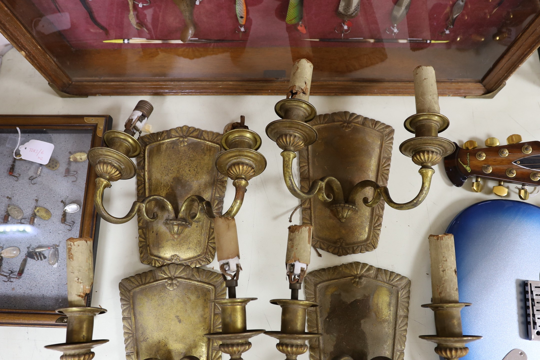 A set of four brass wall sconces